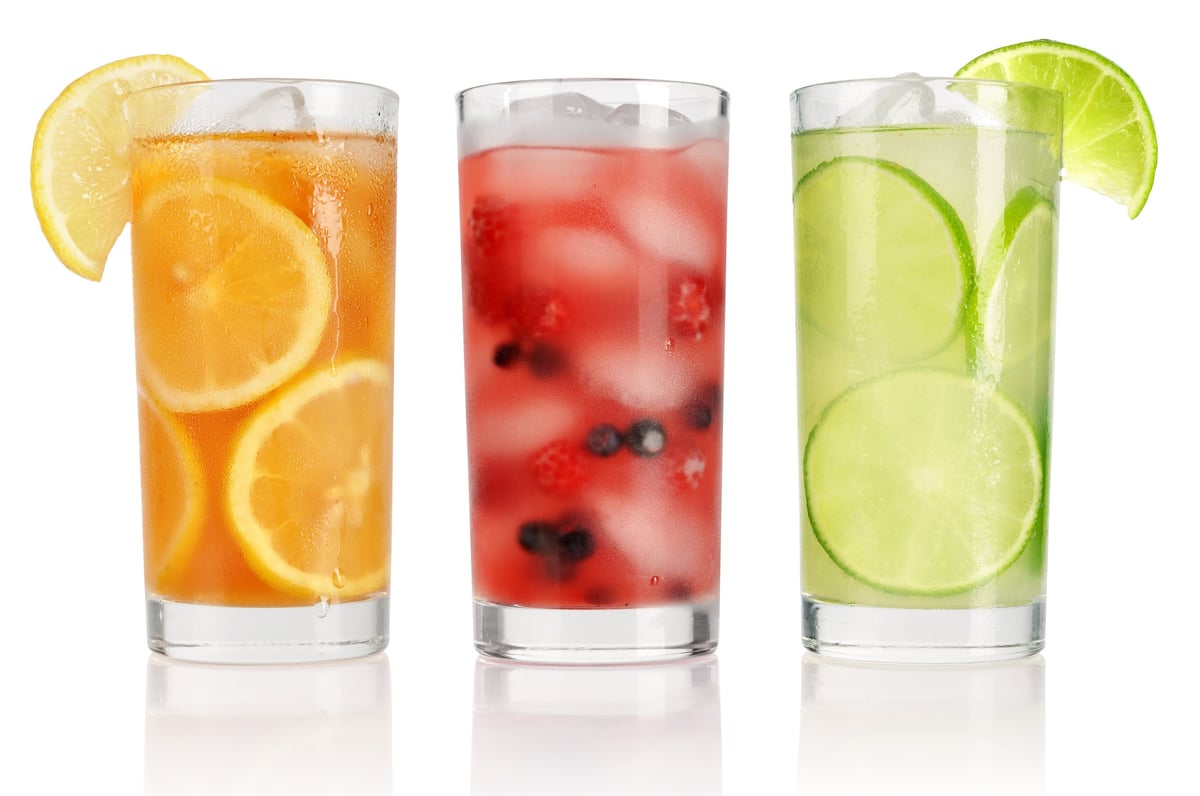 Summer drinks with ice, fresh berries, lemon and lime