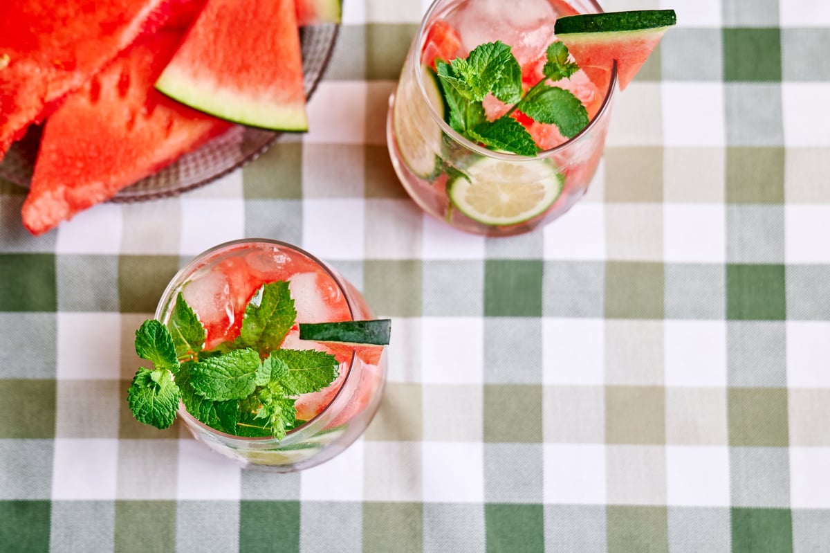 Summer refreshing watermelon drink with ice, mint and slices of lime